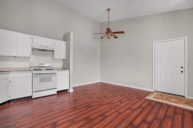 a view of a kitchen with a wooden floor and a sink