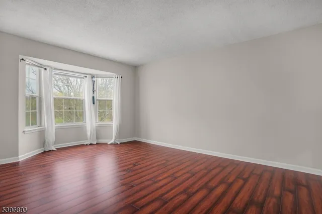 a view of wooden floor and windows in a room