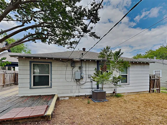 a front view of a house with potted plants