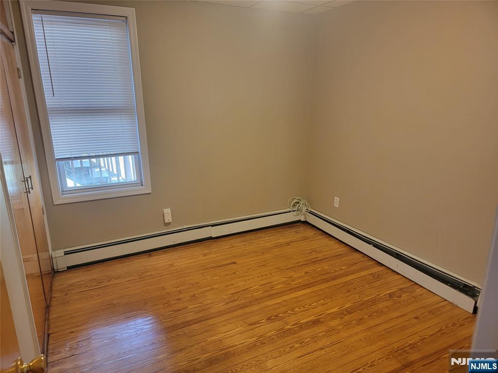 165 Corabelle Avenue, Unit 2 Lodi, NJ 07644 - Photo 6 of 7 a room with a wooden floor and a window