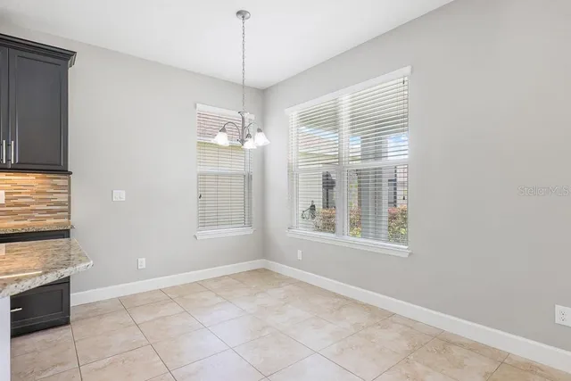 a view of a living room and kitchen with a sink