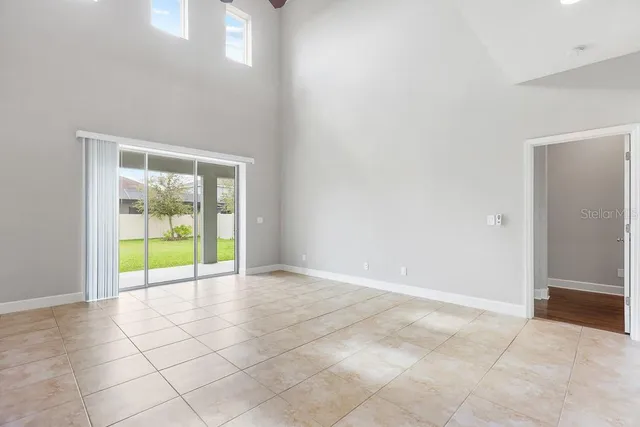 a bedroom with a balcony a bed and a window