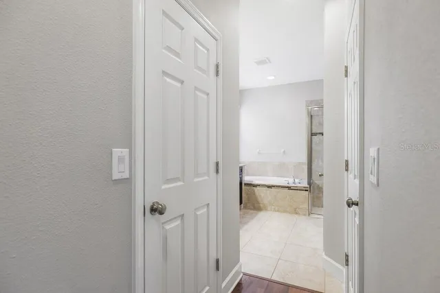 a bathroom with a granite countertop bathtub sink vanity and mirror
