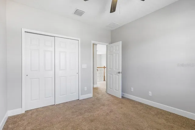 a bathroom with a toilet a sink a mirror and a shower