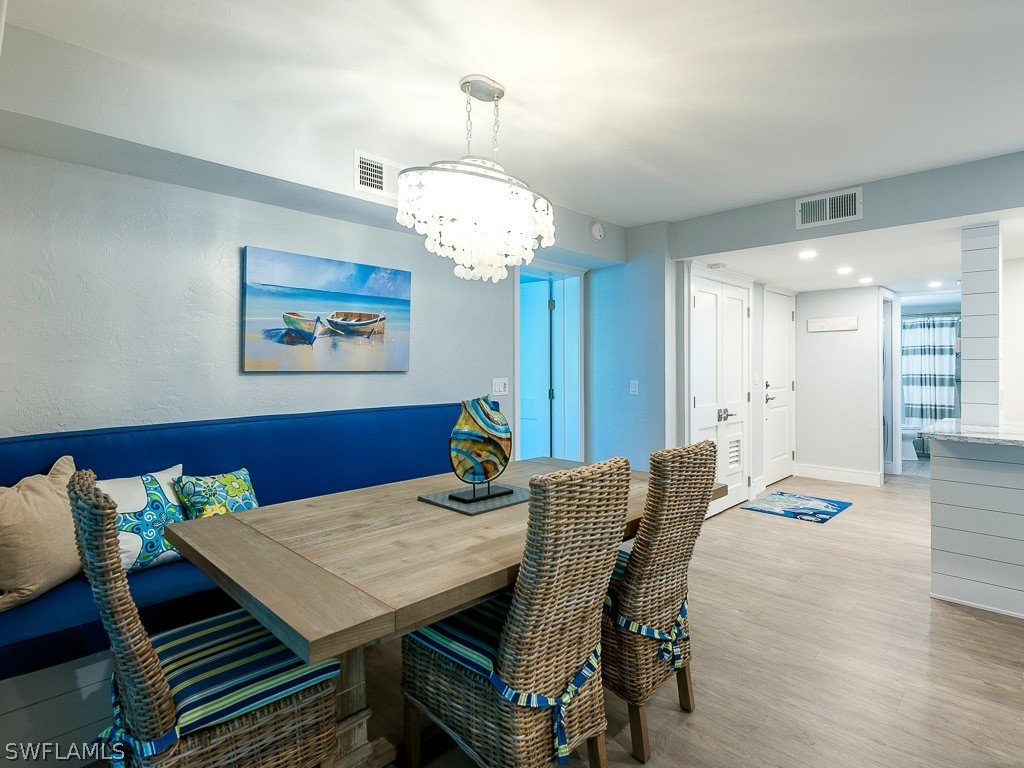 760 Sextant Drive, Unit 732 Sanibel, FL 33957 - Photo 11 of 35 a view of a dining room with furniture wooden floor and chandelier