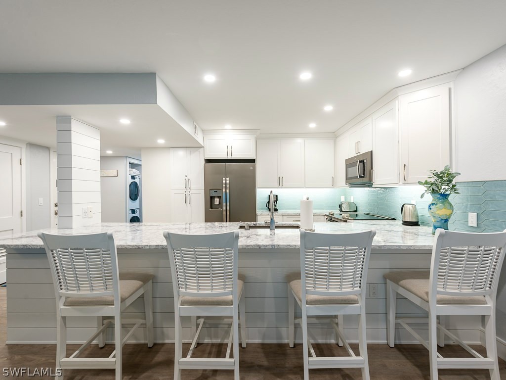 760 Sextant Drive, Unit 732 Sanibel, FL 33957 - Photo 13 of 35 a dining hall with stainless steel appliances kitchen island granite countertop a dining table chairs and view living room