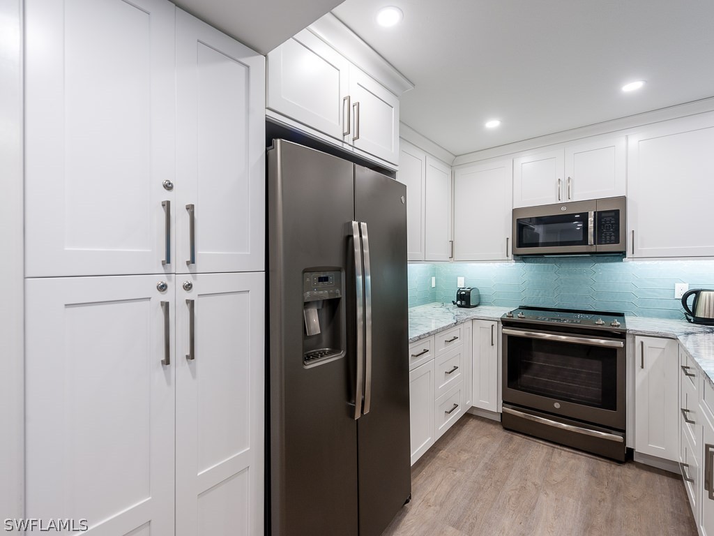 760 Sextant Drive, Unit 732 Sanibel, FL 33957 - Photo 17 of 35 a kitchen with stainless steel appliances granite countertop a refrigerator a stove and a sink