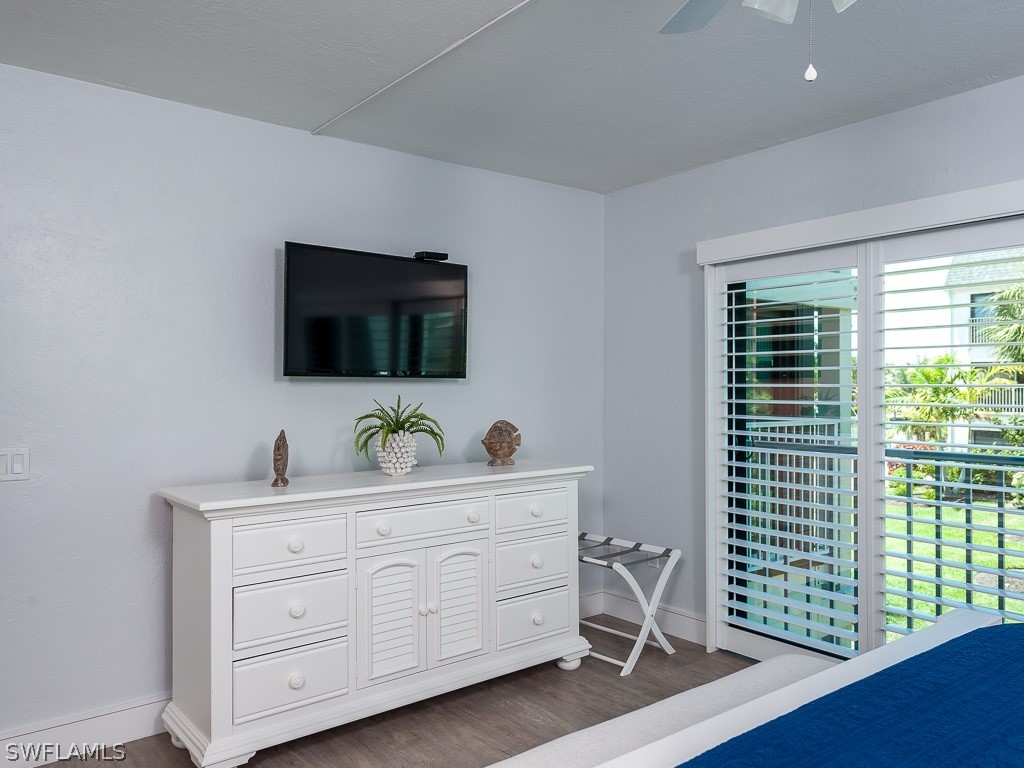 760 Sextant Drive, Unit 732 Sanibel, FL 33957 - Photo 20 of 35 a bedroom with a bed and a flat tv screen on the dresser