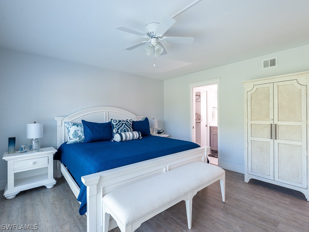 760 Sextant Drive, Unit 732 Sanibel, FL 33957 - Photo 21 of 35 a bedroom with a bed and a chandelier
