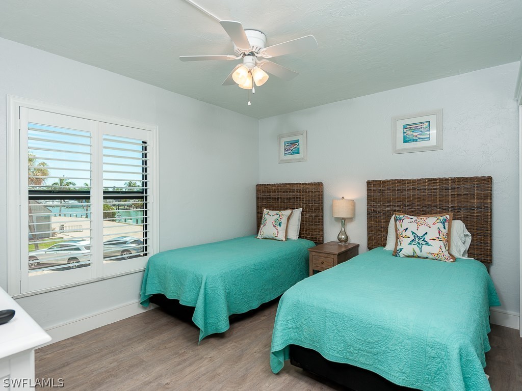 760 Sextant Drive, Unit 732 Sanibel, FL 33957 - Photo 23 of 35 a bedroom with two beds and a chandelier