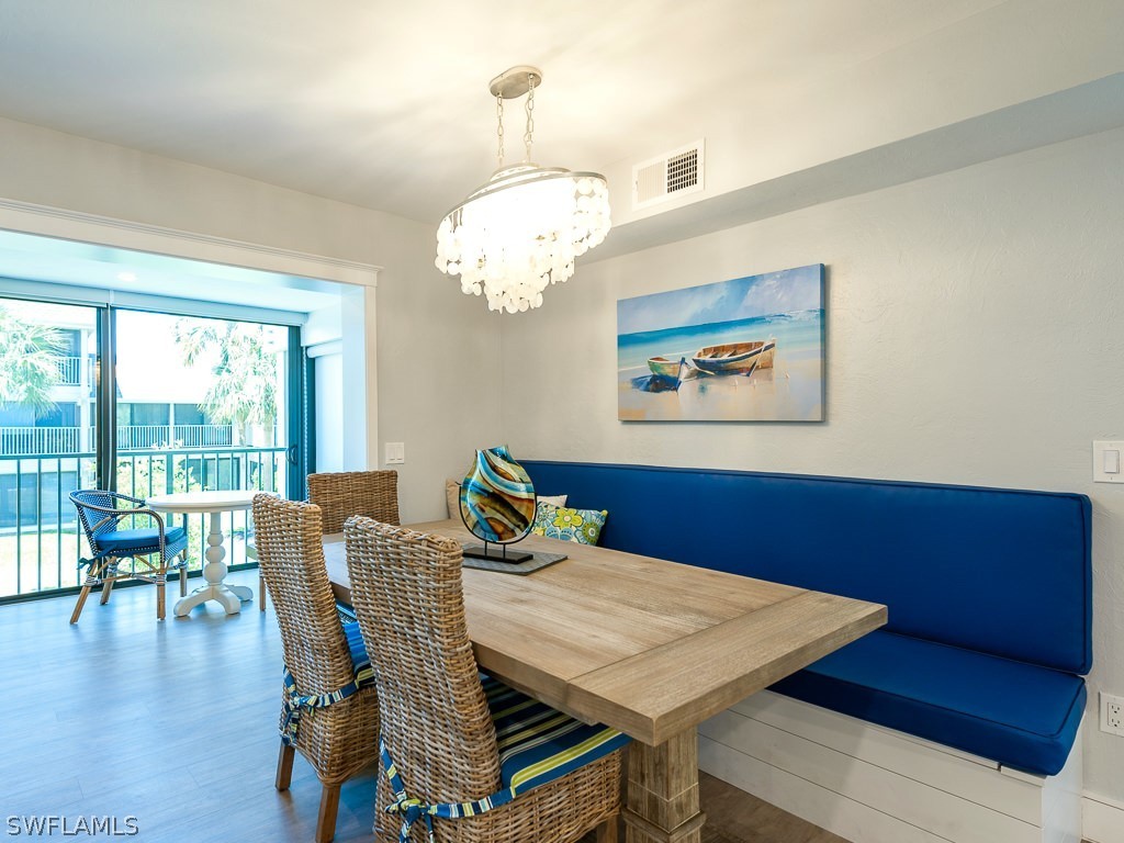 760 Sextant Drive, Unit 732 Sanibel, FL 33957 - Photo 8 of 35 a view of a dining room with furniture wooden floor and chandelier