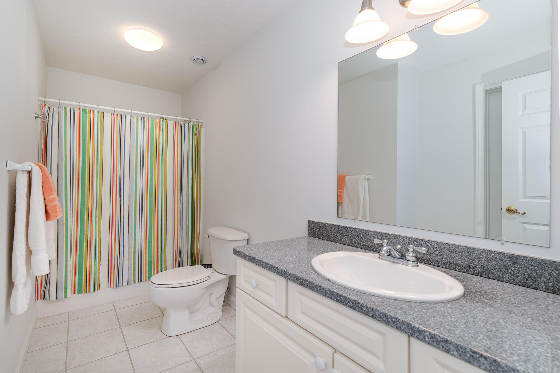 23 Gold Leaf Lane Mashpee, MA 02649 - Photo 24 of 33 a bathroom with a granite countertop sink and a mirror with toilet