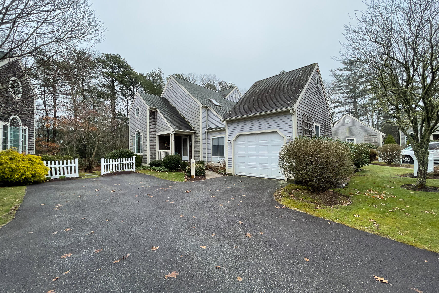 23 Gold Leaf Lane Mashpee, MA 02649 - Photo 26 of 33 a front view of a house with a yard and garage