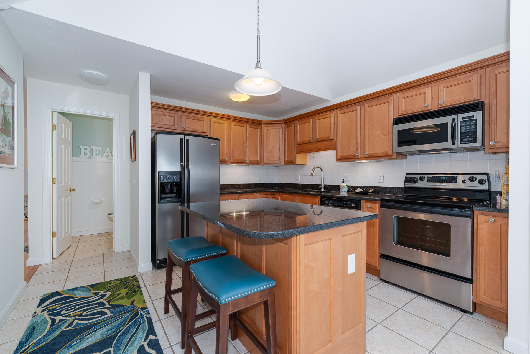 23 Gold Leaf Lane Mashpee, MA 02649 - Photo 8 of 33 a kitchen with stainless steel appliances granite countertop a stove a sink and a refrigerator