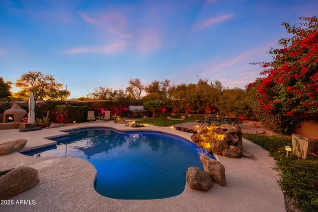 a view of a swimming pool with outdoor seating and plants