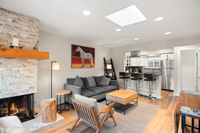 a living room with furniture a fireplace and a flat screen tv