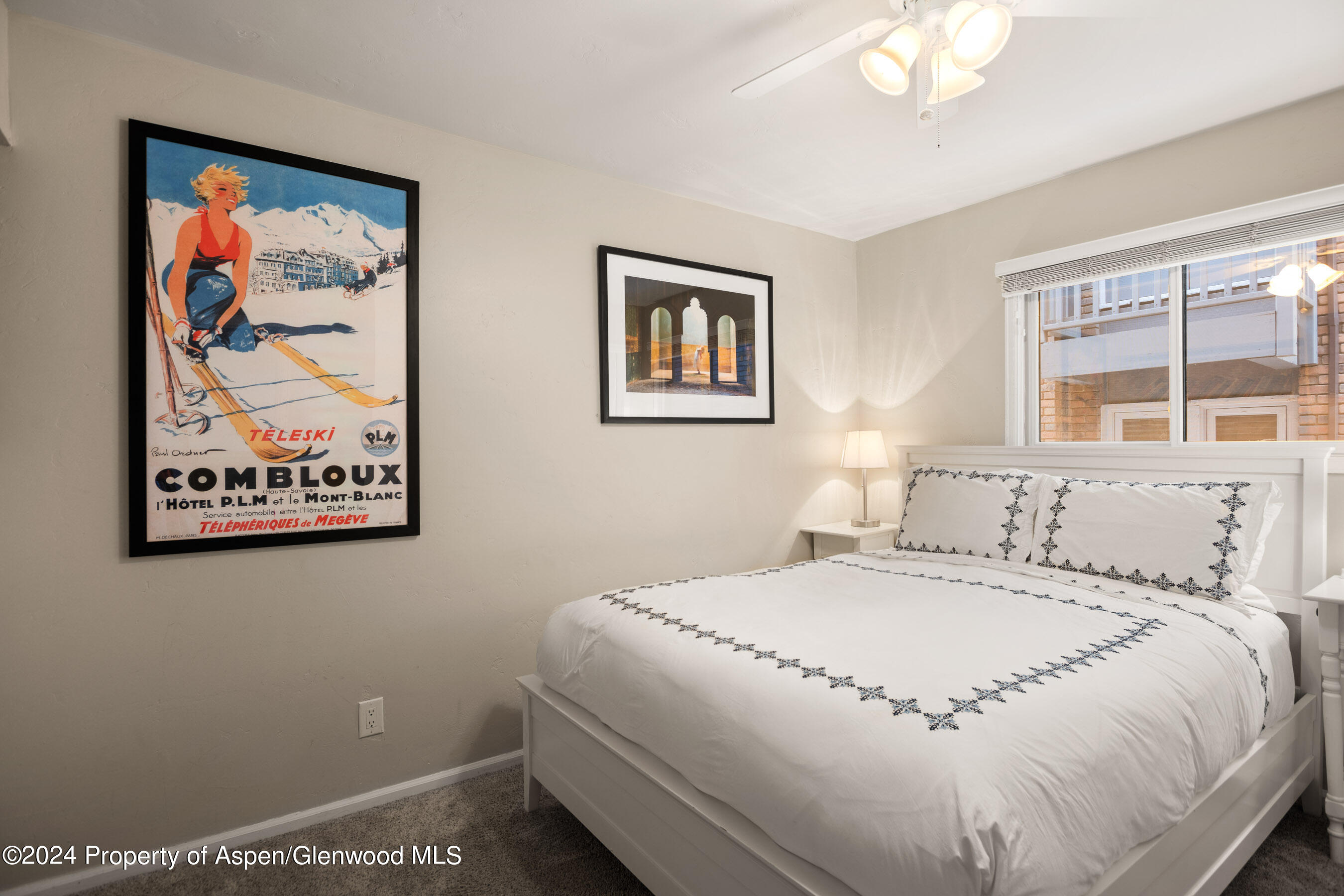 108 West Hyman Avenue, Unit 3 Aspen, CO 81611 - Photo 8 of 12 a bedroom with a bed and a painting on the wall