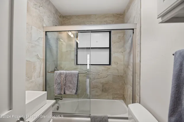 a bathroom with a tub and shower