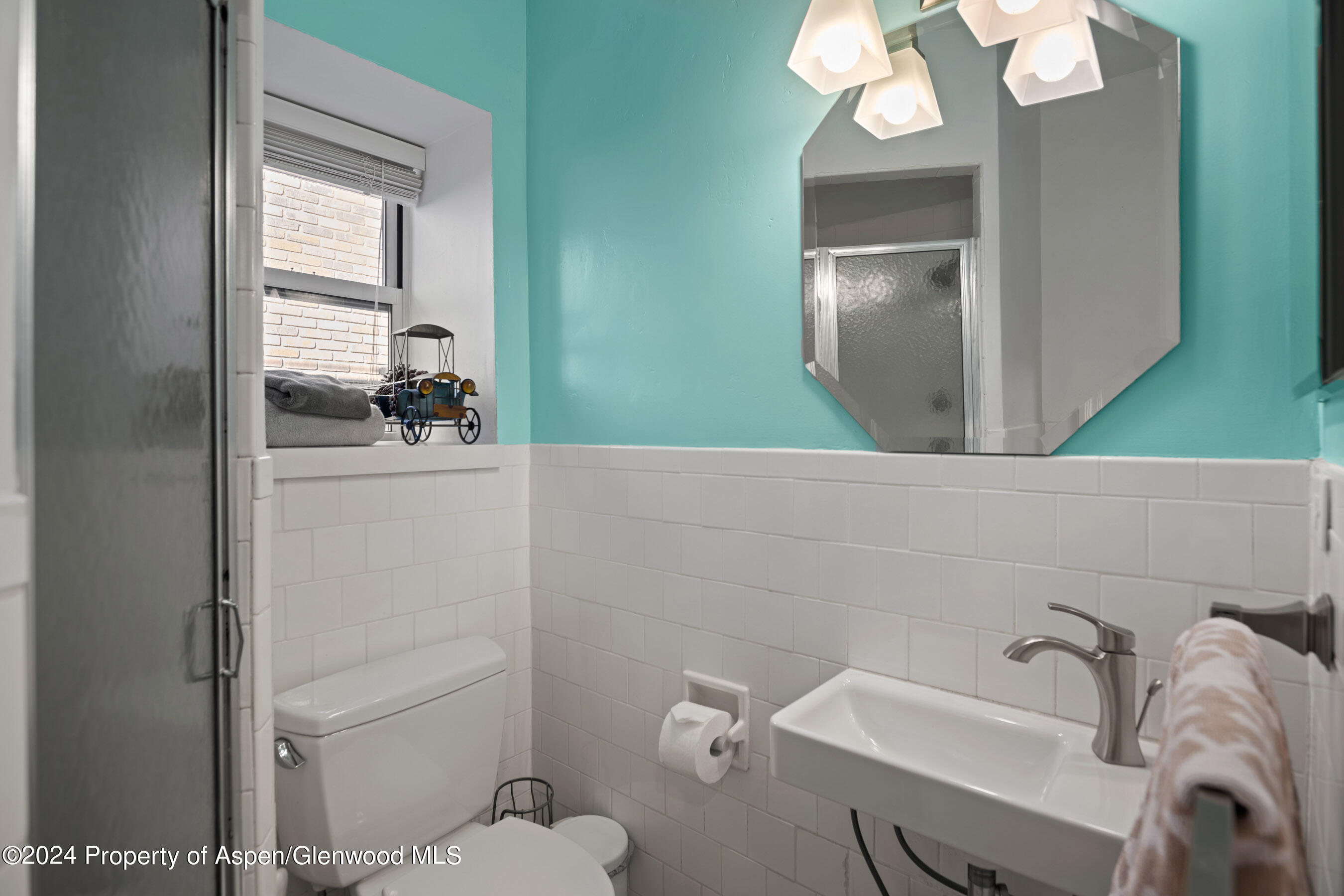 108 West Hyman Avenue, Unit 3 Aspen, CO 81611 - Photo 10 of 12 a bathroom with a sink a toilet and mirror