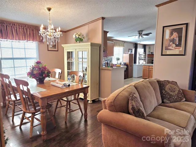 a living room with furniture dining table and a chandelier