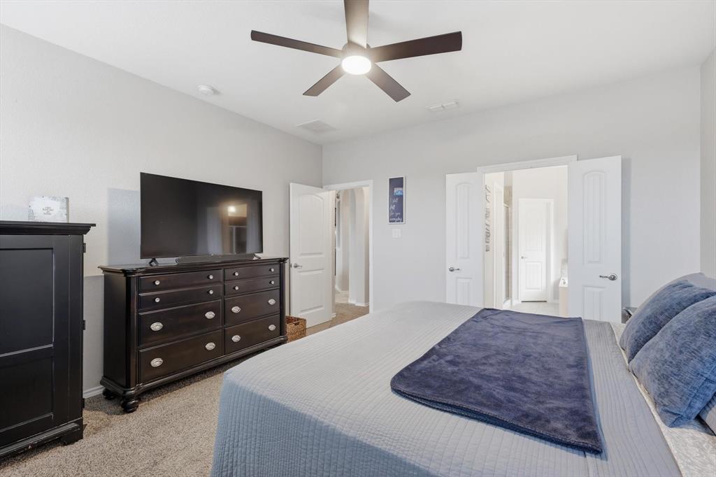 11500 Starlight Ranch Fort Worth, TX 76052 - Photo 20 of 40 Bedroom with light-colored walls and carpet flooring, featuring an overhead ceiling fan with a light fixture