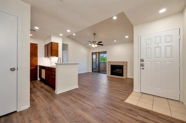 an open kitchen with a refrigerator and a stove top oven