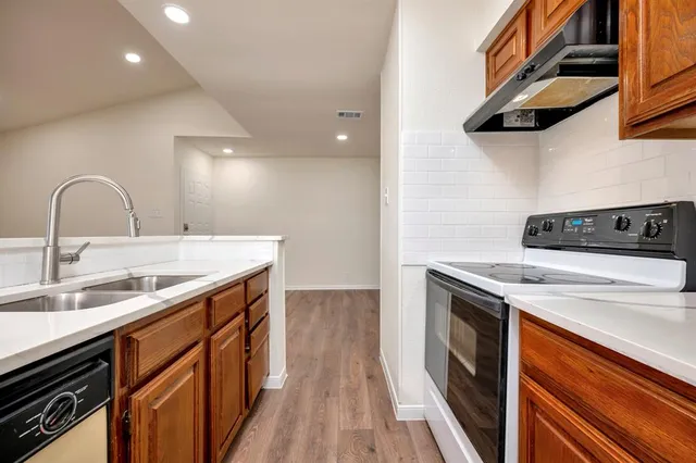 a kitchen with a sink and a stove top oven