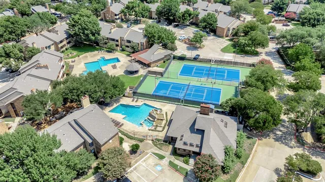 an aerial view of a house with a yard and lake view