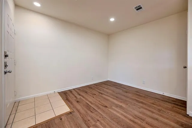 an empty room with wooden floor