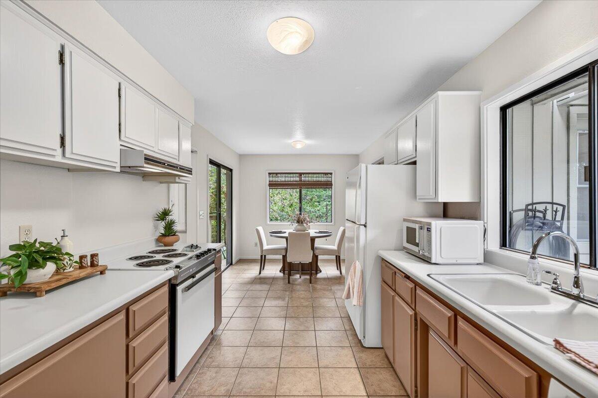 2647 Freedom Way Medford, OR 97504 - Photo 19 of 38 a kitchen with stainless steel appliances granite countertop a sink counter space cabinets and a large window
