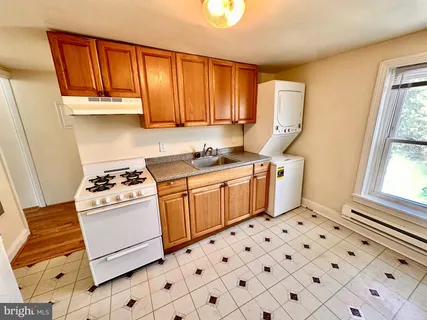 a kitchen with stainless steel appliances a stove a sink and a refrigerator