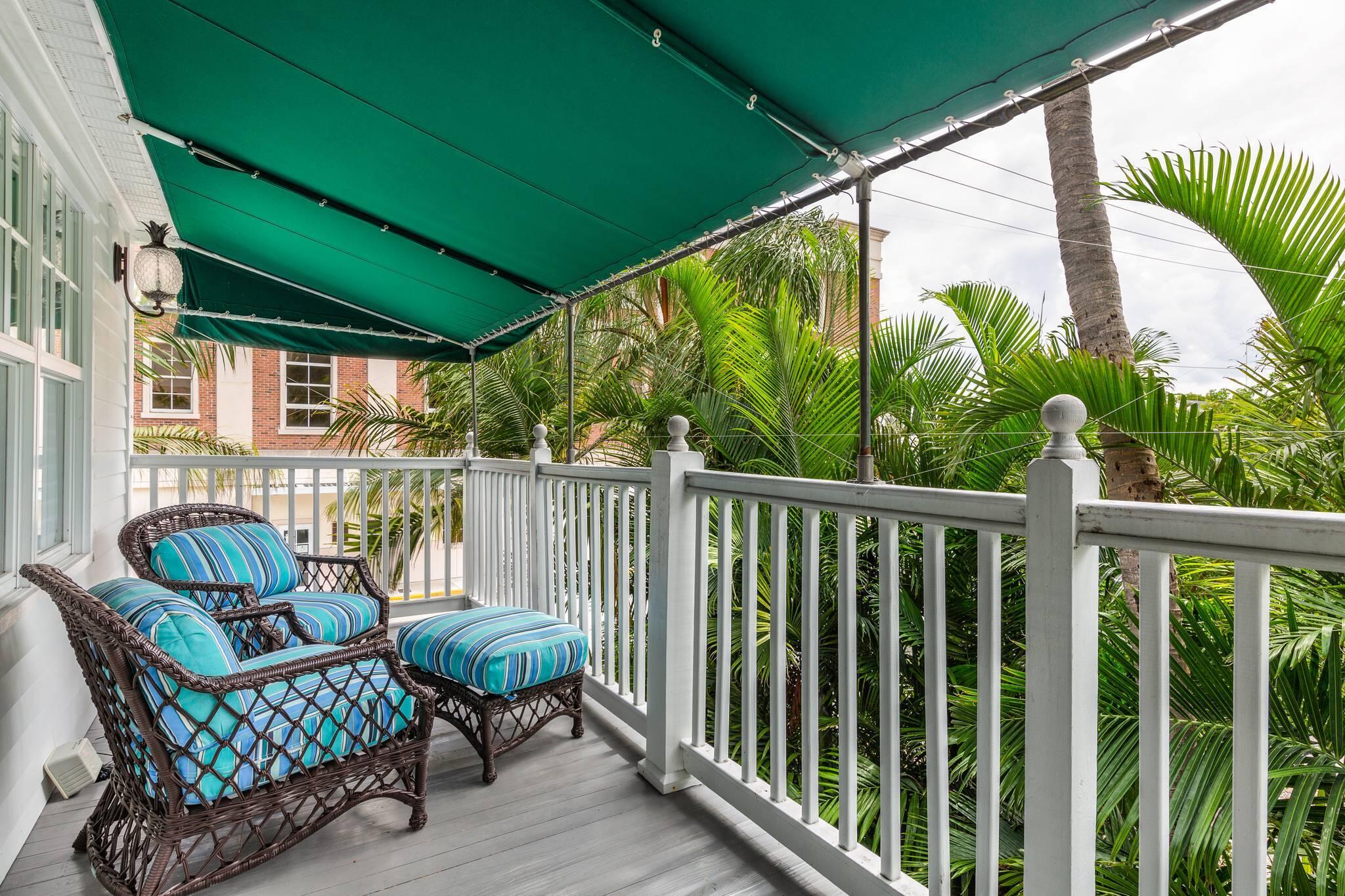 216 Fleming Street Key West, FL 33040 - Photo 25 of 33 a view of a chair in wooden deck