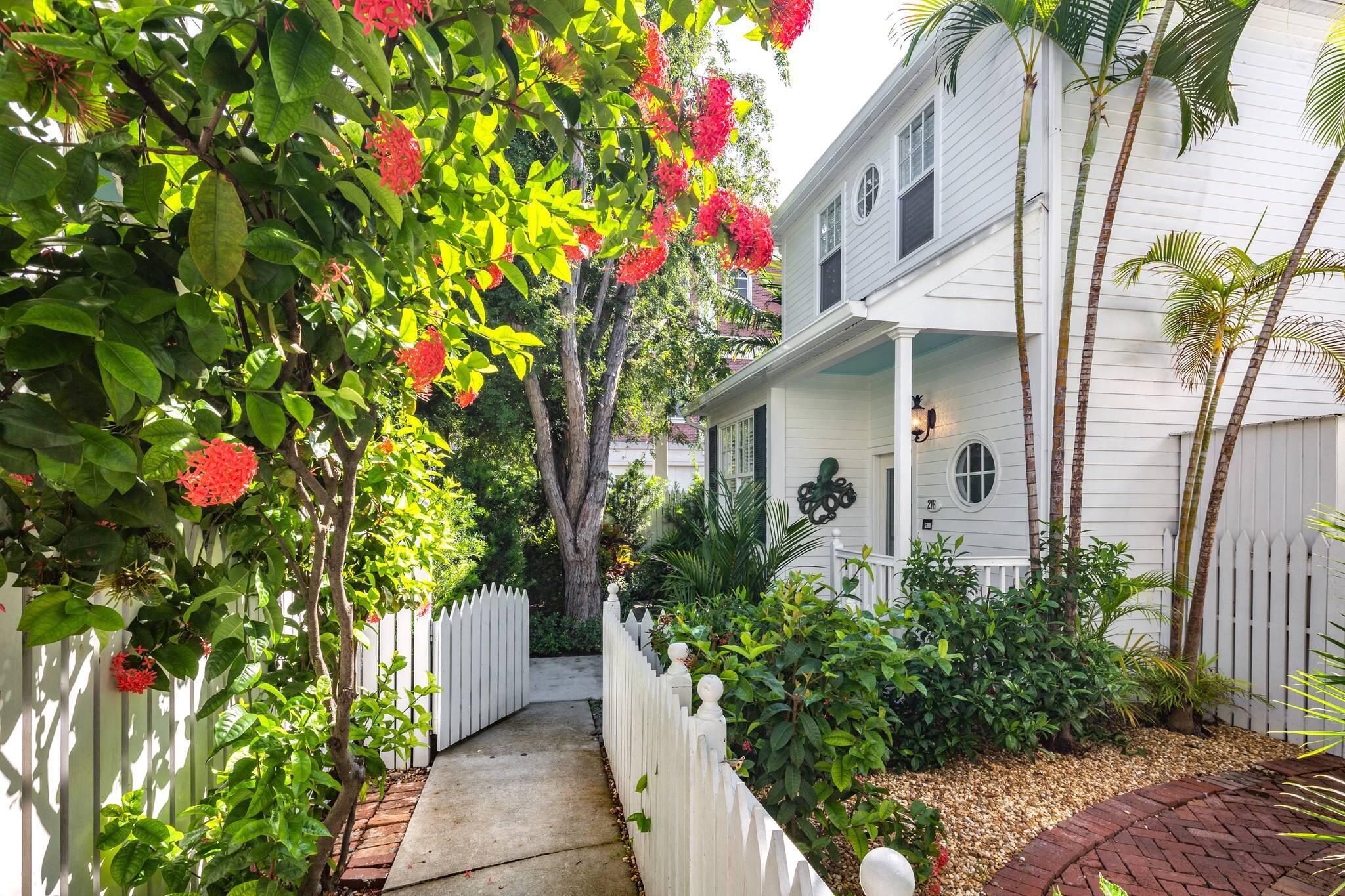 216 Fleming Street Key West, FL 33040 - Photo 33 of 33 a front view of a house with a flower garden
