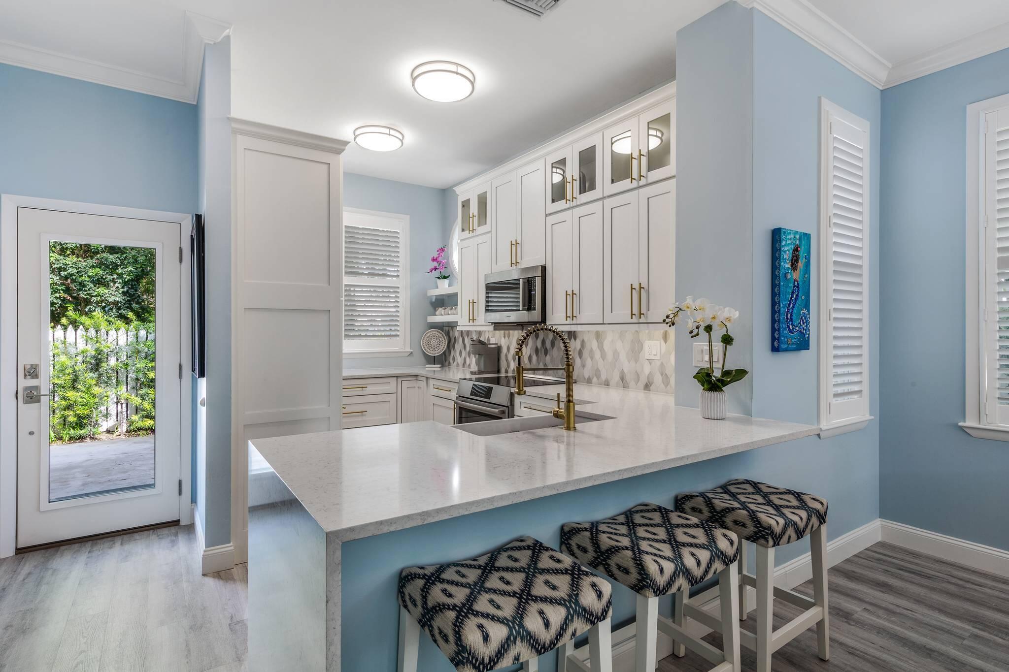 216 Fleming Street Key West, FL 33040 - Photo 10 of 33 a kitchen with sink cabinets and window