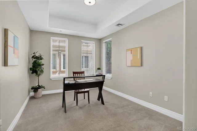 a view of a workspace with furniture and a window