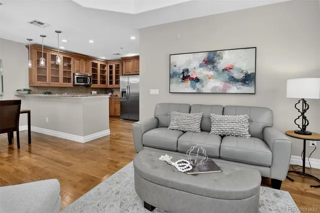 a living room with furniture a couch and a painting on the wall