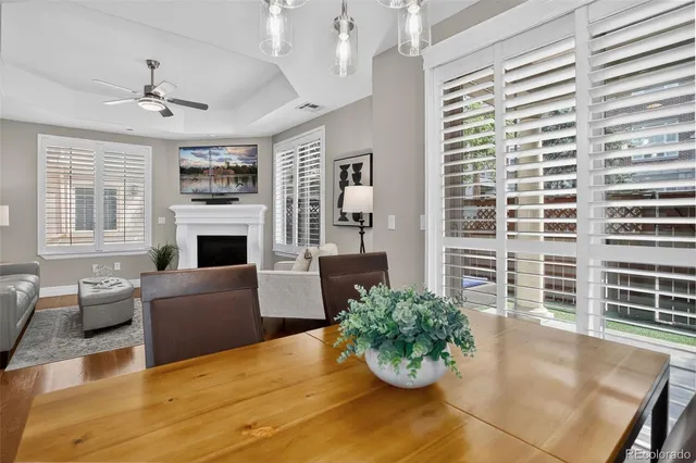 a living room with furniture potted plant and kitchen view