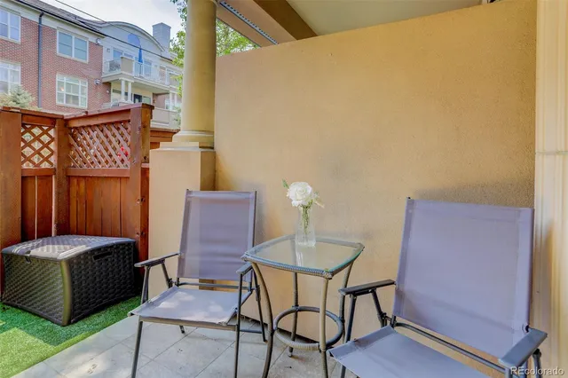 a backyard of a house with table and chairs