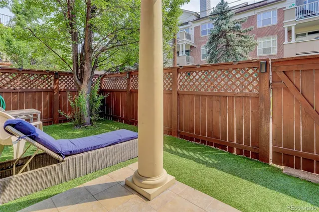 a view of a backyard with wooden fence