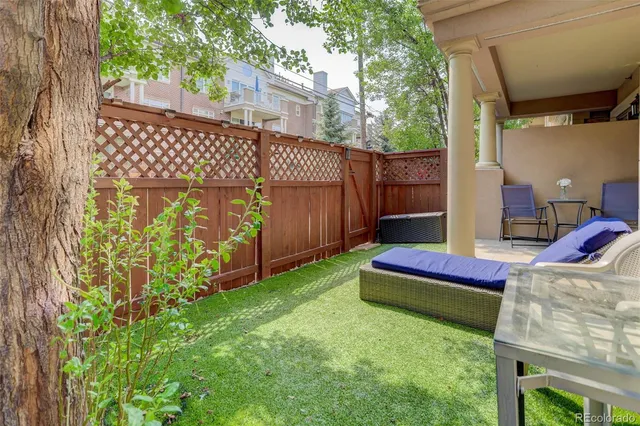 a wooden bench sitting in front of a building