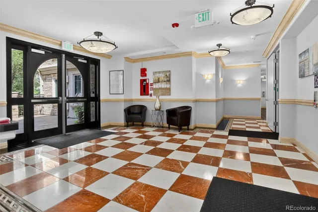a room with a black white checkered floor kitchen view and a fireplace