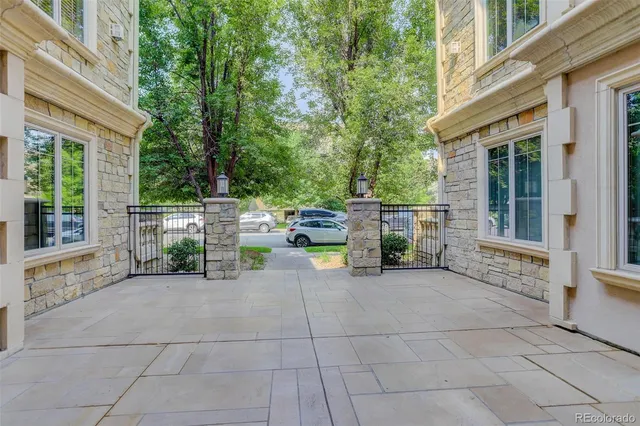 a view of a patio with table and chairs and potted plants