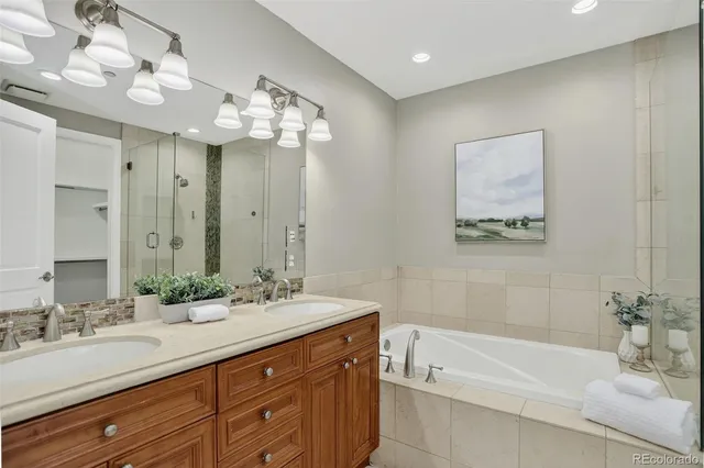 a bathroom with a bathtub sink and mirror
