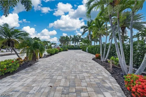 a view of a swimming pool with a patio and a yard