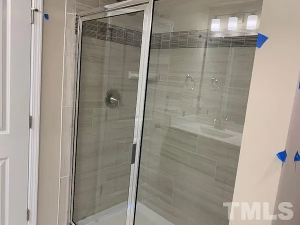 a bathroom with a glass shower door