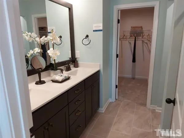 a bathroom with a sink vanity and mirror