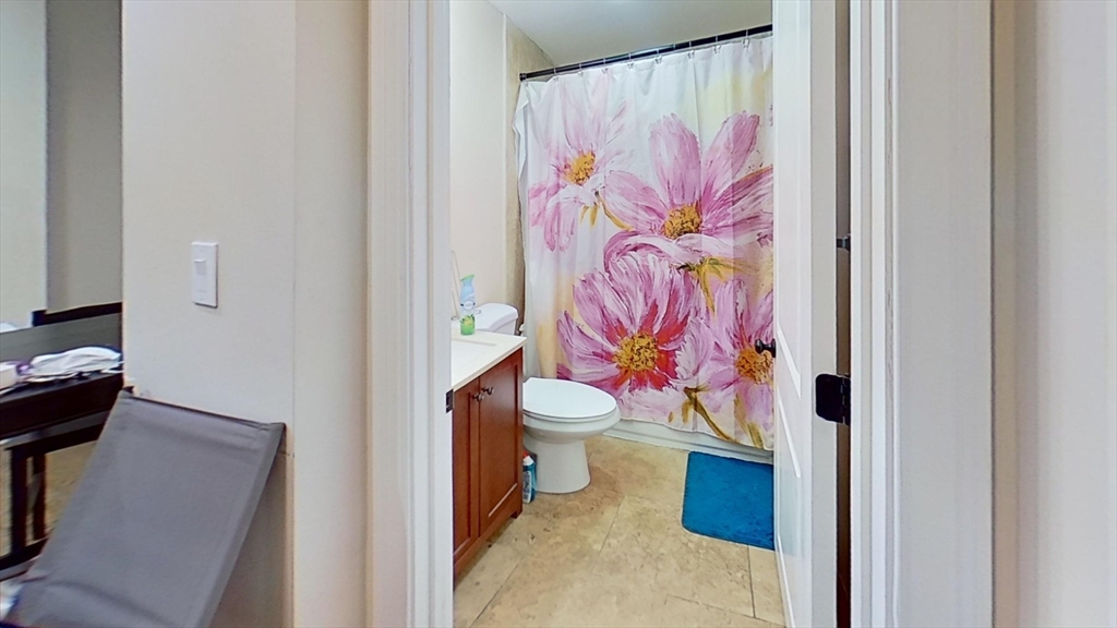 2975 Washington Street, Unit 1 Boston, MA 02119 - Photo 7 of 8 a bathroom with a toilet and shower curtain