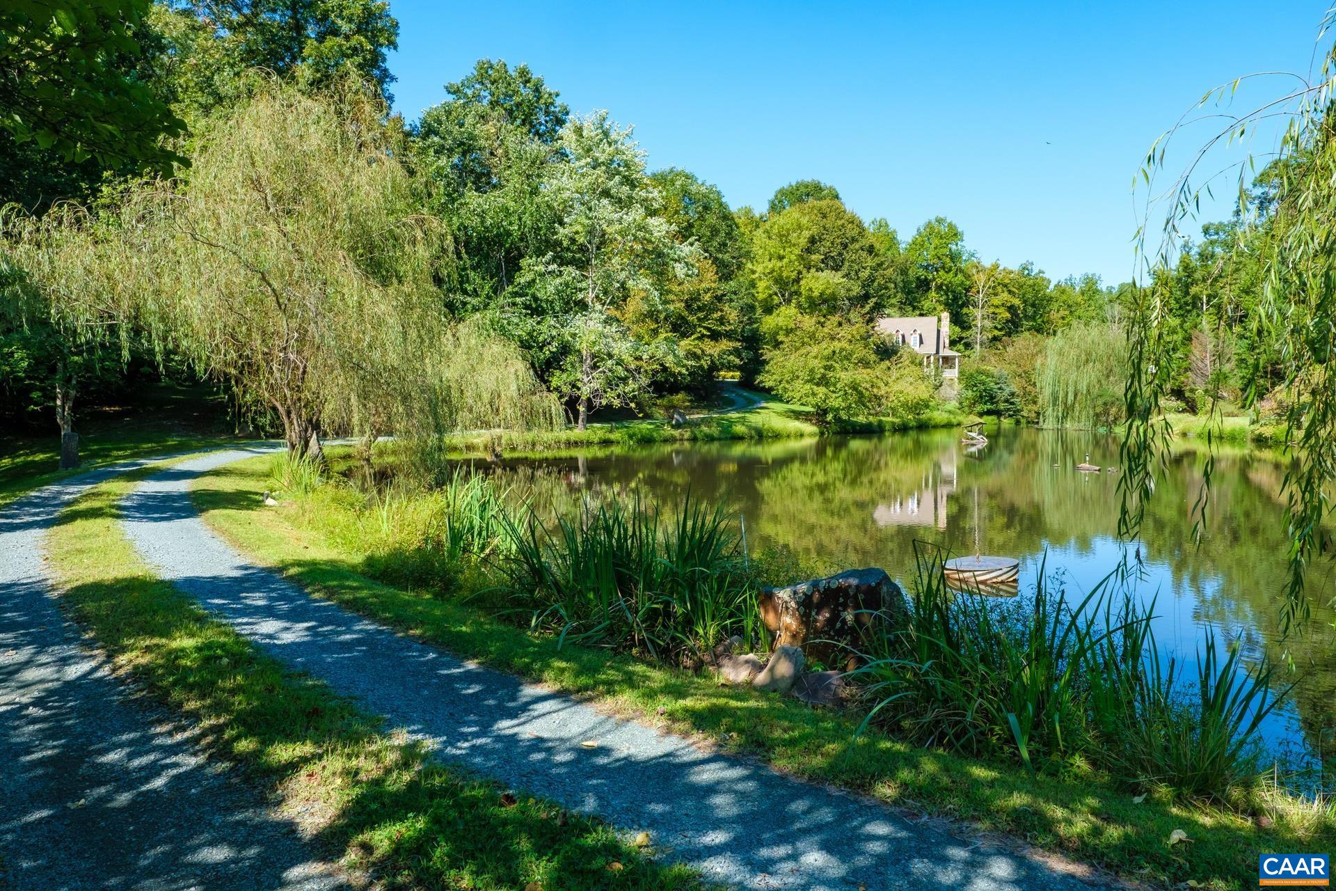 684 Campbell Road Keswick, VA 22947 - Photo 11 of 51 a view of a lake with a big yard