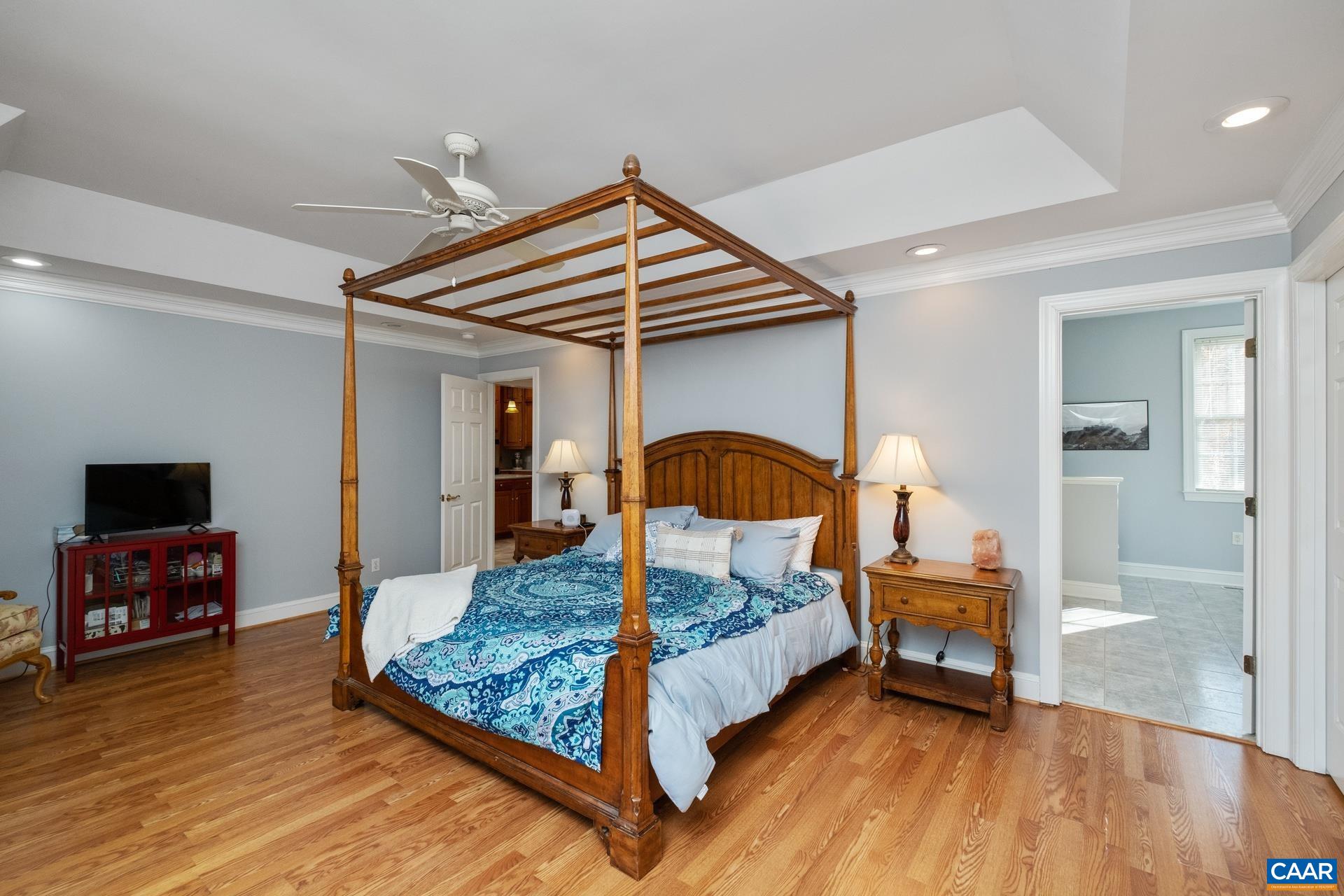 684 Campbell Road Keswick, VA 22947 - Photo 27 of 51 a bedroom with a bed and wooden floor