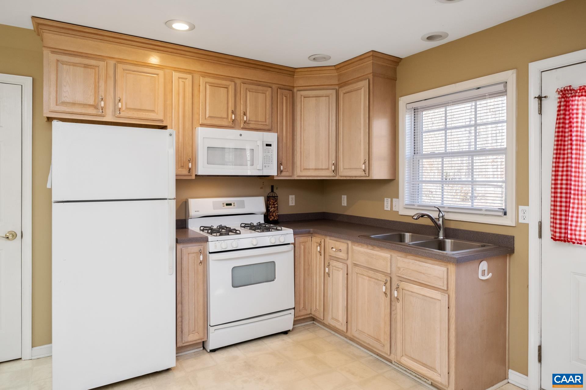 684 Campbell Road Keswick, VA 22947 - Photo 44 of 51 a kitchen with stainless steel appliances granite countertop a sink stove and refrigerator